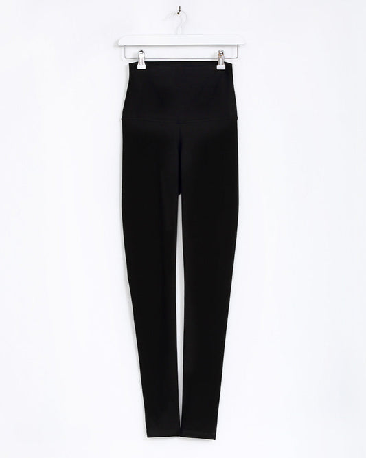Black leggings on a white hanger against a white background